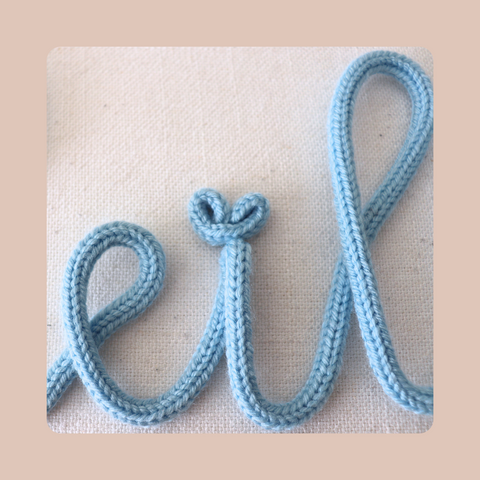 Custom knitted name or custom knitted word sign with mini heart or pom pom.